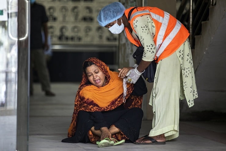 A woman mourning for the death of her relative during COVID19